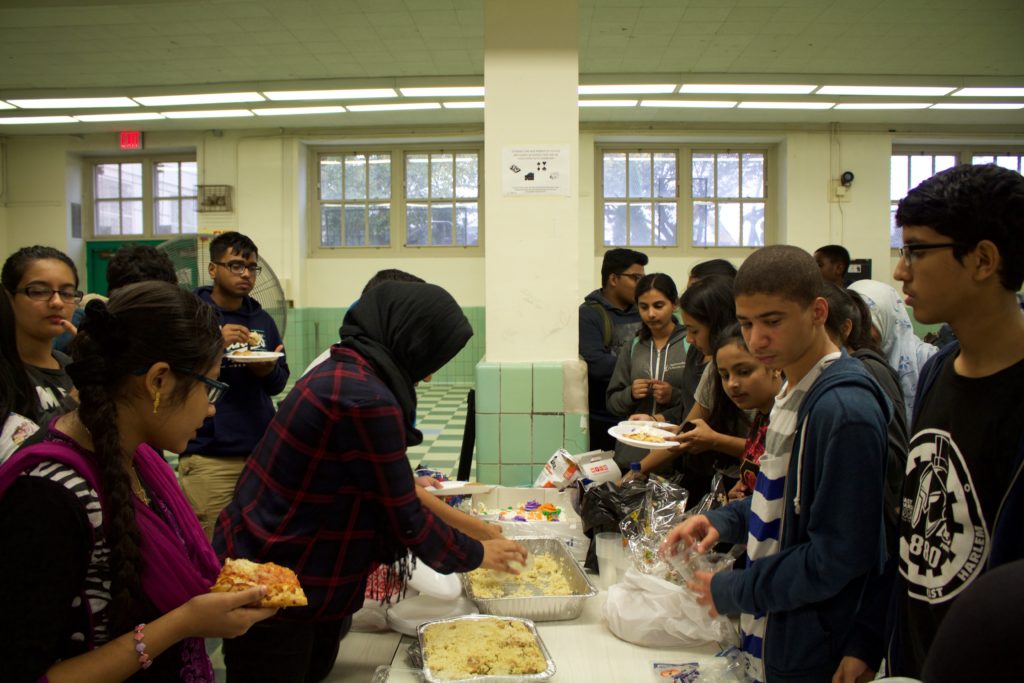 Enjoying food at the Eid party in the MCSM cafeteria.